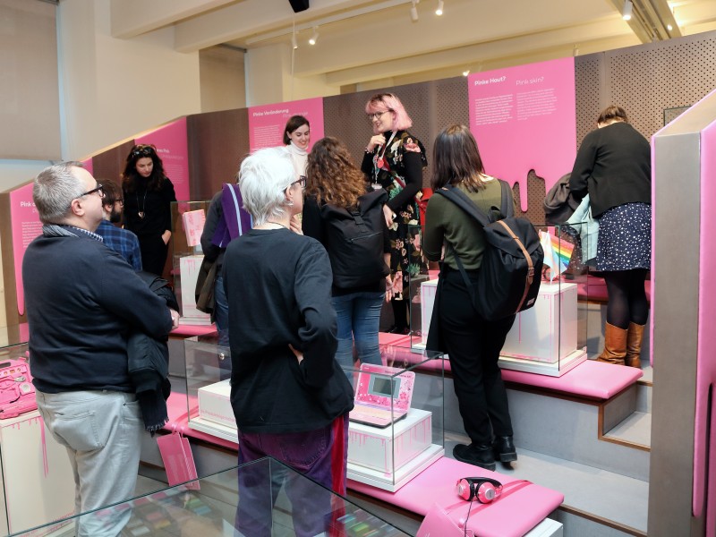 Menschen stehen in einer Ausstellung mit Pink Gestaltung