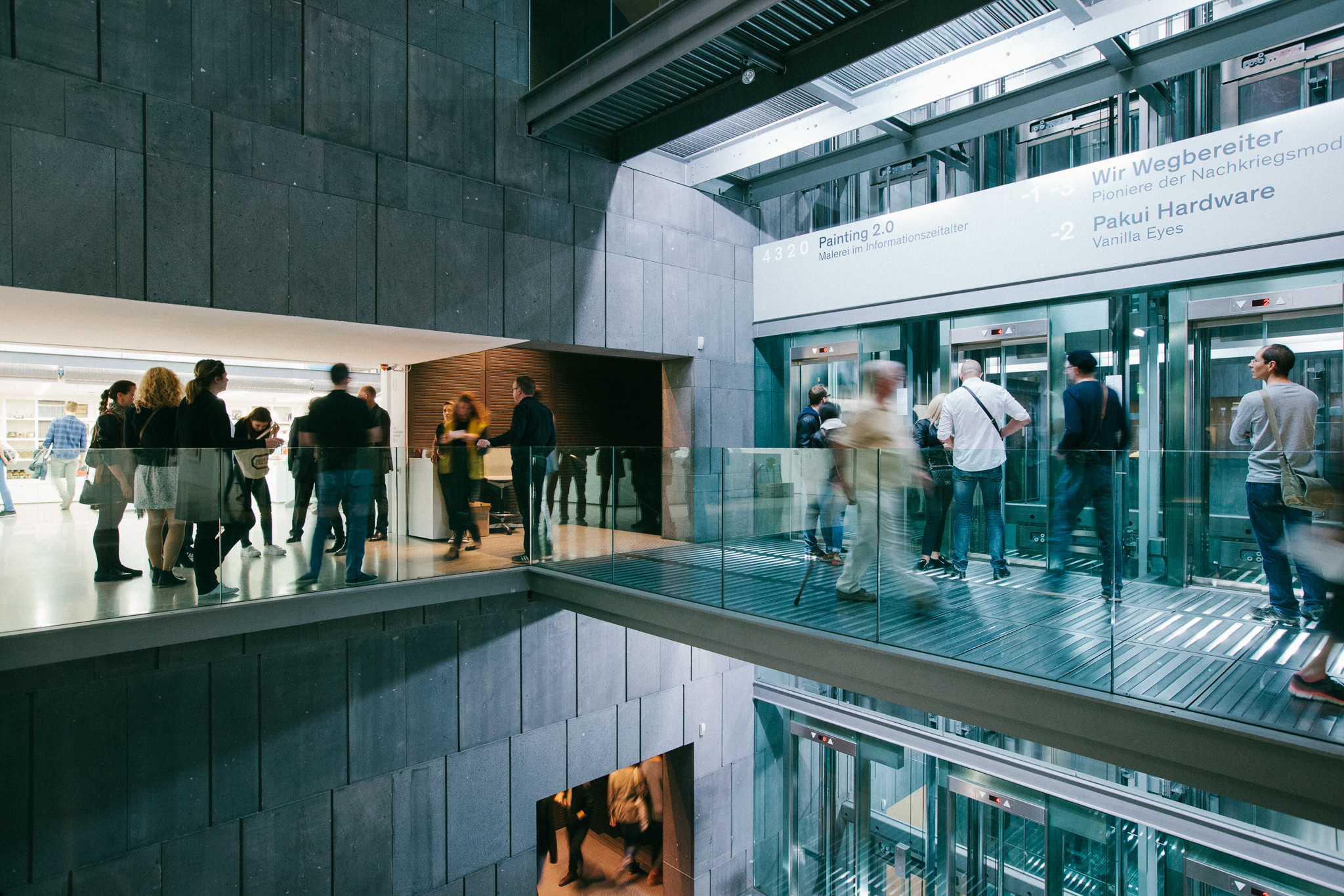 Eine modernes Museumsgebäude mit Beton und Glas Architektur und vieler Menschen in Bewegung